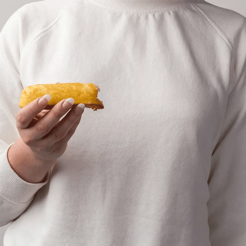 GIF of a person holding a Twinkie. Another person inserts a can of whipped cream and squeezes it in. The person holding the Twinkie then inserts a Awkward Essentials Dripsticks to showcase how it absorbs and removes the whipped cream. | Kinkly Shop