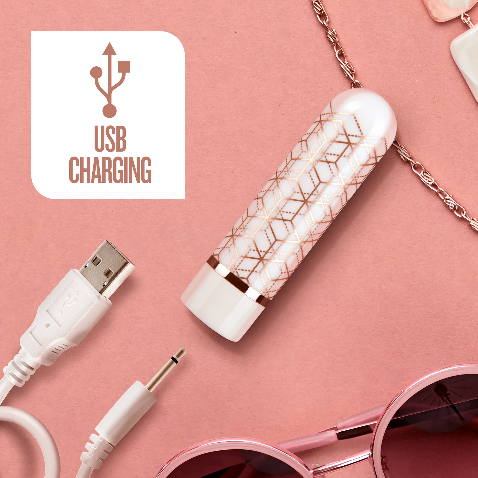 Blush Glitzy rose gold bullet vibrator near its USB charger to display its rechargeable design | Kinkly Shop