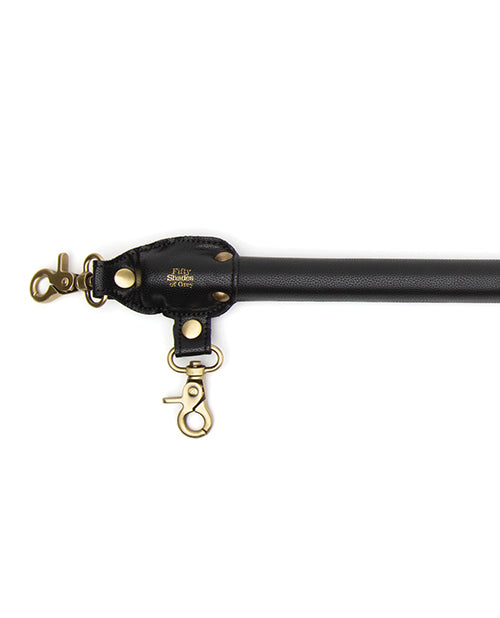 View of the faux leather tips that attach the two, easy-release clasps to the Fifty Shades of Grey Bound to You Spreader Bar | Kinkly Shop