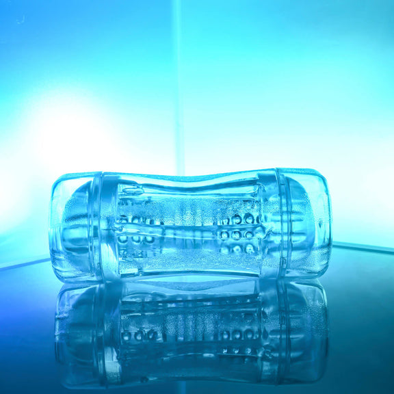 The Gender X Double Fantasy against a blue background. This showcases the see-through design of the stroker and the internal texture. | Kinkly Shop