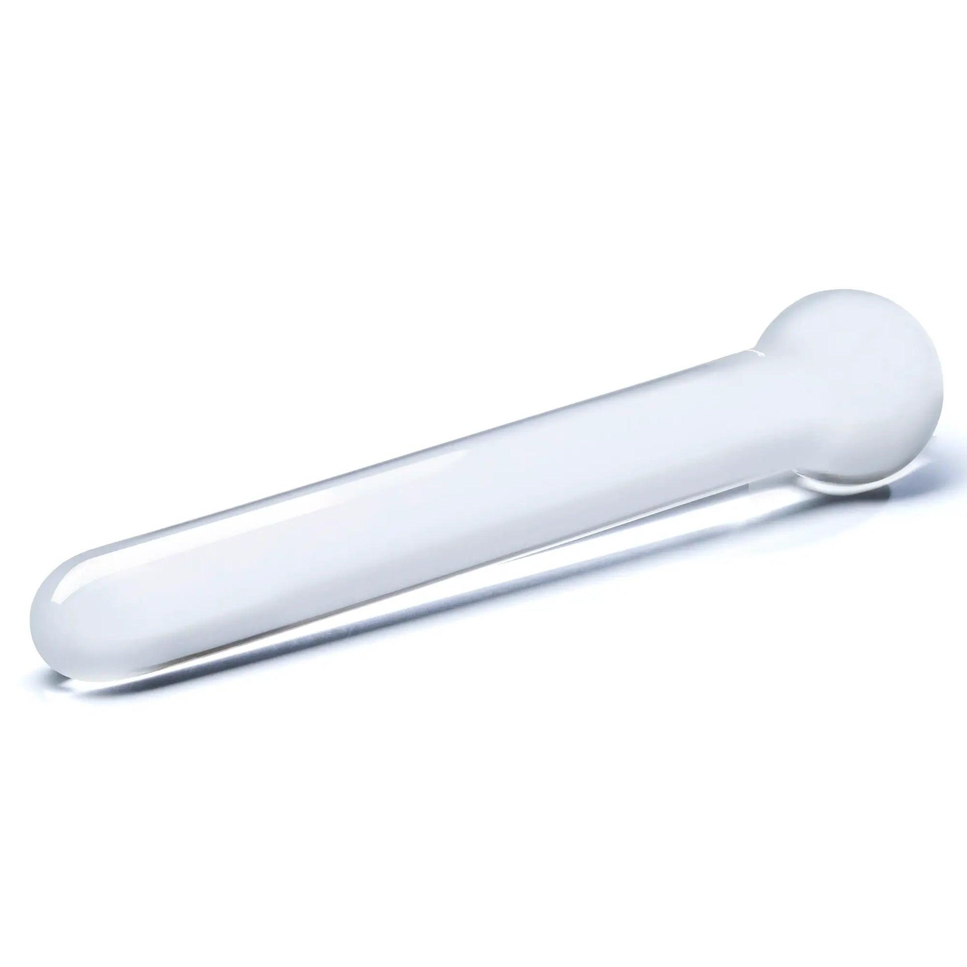 The Glas 7" Straight Glass dildo laying out flat against a white surface. This showcases the untextured shaft of the dildo in addition to the sphere-like design of the base. | Kinkly Shop
