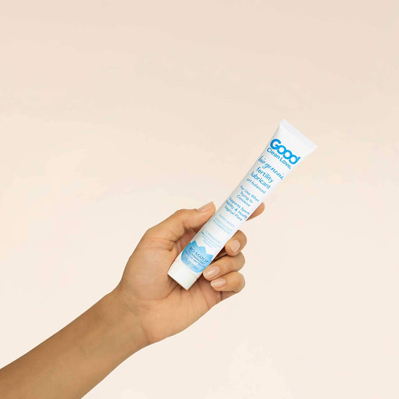 A hand holding the 2 oz bottle of Good Clean Love BioGenesis™ Fertility Lubricant | Kinkly Shop