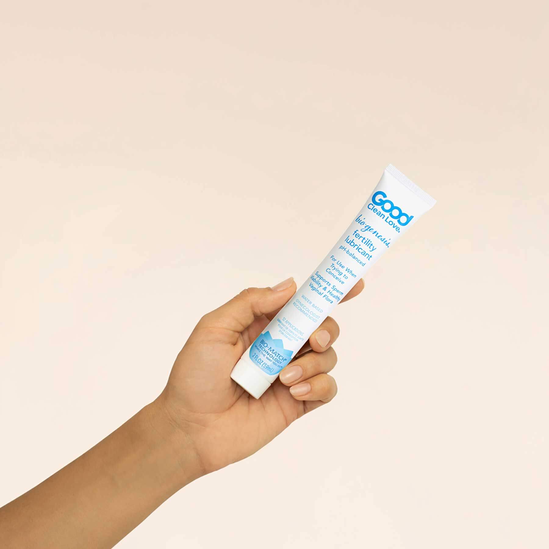 A hand holding the 2 oz bottle of Good Clean Love BioGenesis™ Fertility Lubricant | Kinkly Shop