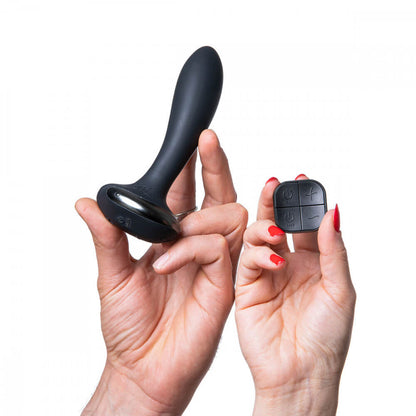 Two hands are holding the Hot Octopuss PleX with Flex toy. One hand holds the insertable plug while the hand next to it holds the remote control for the Hot Octopuss PleX with Flex. | Kinkly Shop