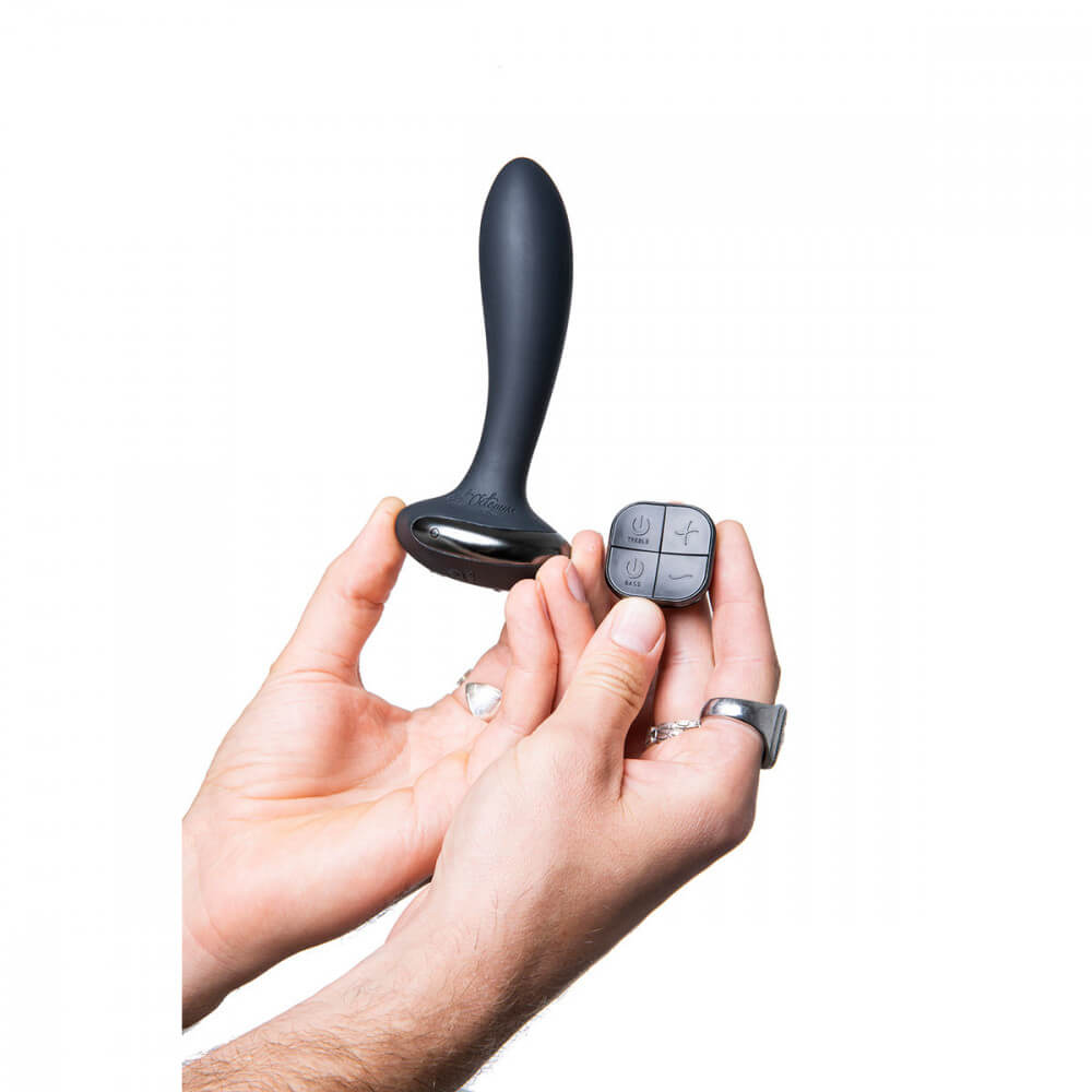 Two hands are holding the Hot Octopuss PleX with Flex toy. One hand holds the insertable plug while the hand next to it holds the remote control for the Hot Octopuss PleX with Flex. | Kinkly Shop