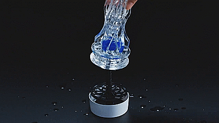 GIF showing a person placing the Elastomer sleeve of the Tenga Aero Cobalt onto the drying stand. The image shows the squishy, stretchy properties of the internal sleeve. | Kinkly Shop