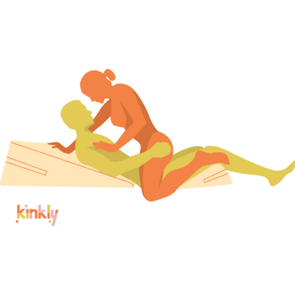 Illustration shows the Liberator Wedge and Liberator Ramp in use. The penetrating partner is laying "flat" on the ground. The Ramp props up their back and the Liberator Wedge props up their thighs. The receiving partner is in Partner-on-Top position. The change of angle provides better g-spot positioning. | Kinkly Shop