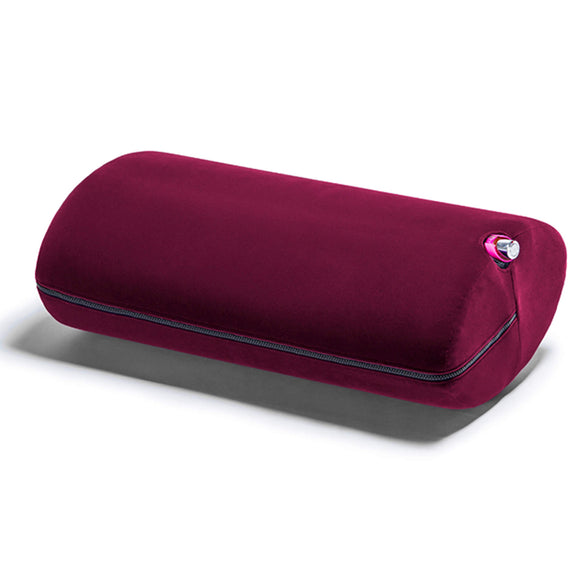 Liberator Wing in Merlot. A sex toy is inserted into the sex toy mount's hole on the side of the shape. Only the base of the vibrator is visible as the vibrator vibrates the entirety of the Wing's size. | Kinkly Shop
