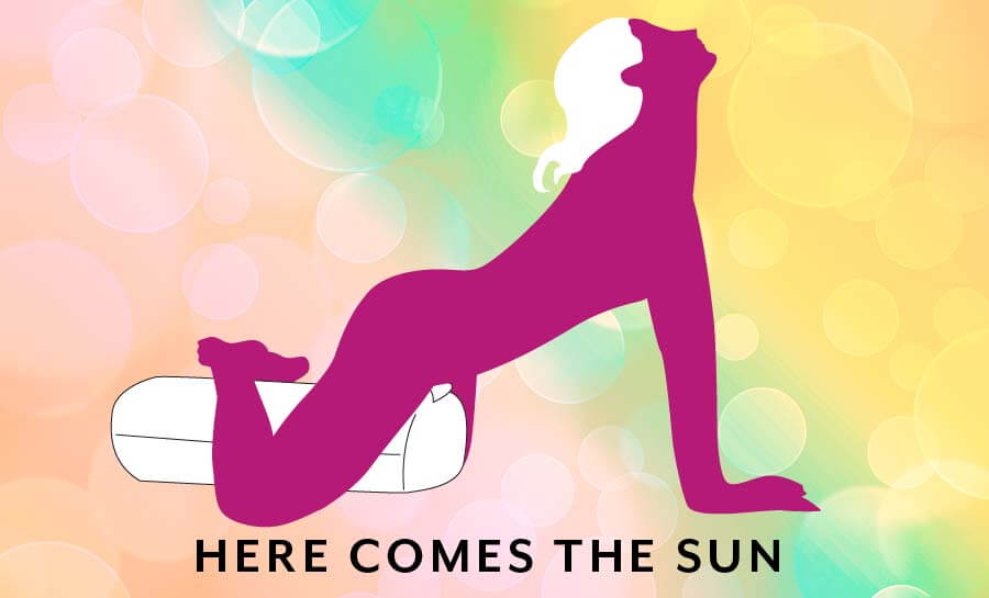 Illustrated sex position. Titled "Here Comes the Sun". The Liberator Wing has a powerful vibrator slipped into it. A person is straddling the Wing with between their thighs pressed firmly into the shape as it vibrates. | Kinkly Shop