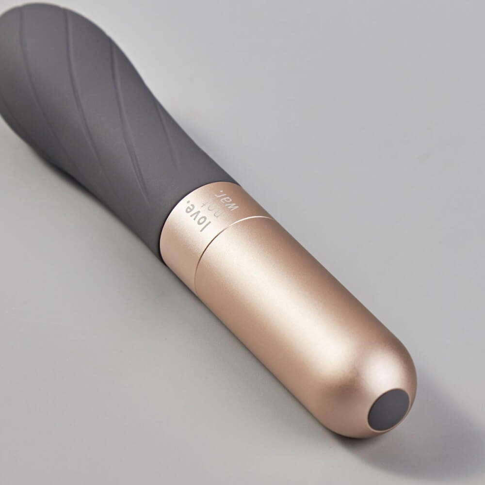Close-up on the base and texture of the Love Not War Grá. This angle showcases the extremely smooth aluminum handle - and the swirling texture that the tip is etched with. | Kinkly Shop