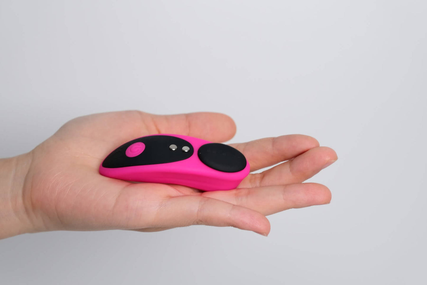 Lovense Ferri held in the palm of a person's hand against a plain white background. The vibe is slender compared to the person's palm. | Kinkly Shop