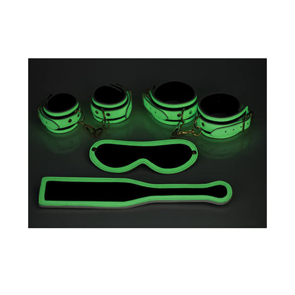This glow-in-the-dark image shows the same set-up as the previous photo - only now all of the lights are off. All of the parts of the Master Series Kink in the Dark Set that were white now glow with a green hue in the dark. | Kinkly Shop