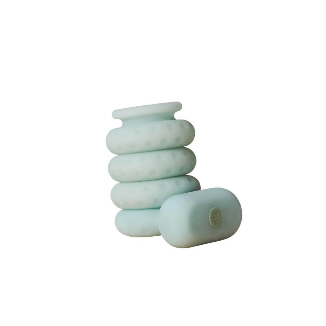 The OhNut Vibrating Ring and a set of original OhNut all wrapped together against a white background. This angle shows how seamlessly the OhNut Vibrating Ring fits into the OhNut stack. It looks like it's part of the original OhNut series. | Kinkly Shop