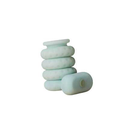 The OhNut Vibrating Ring and a set of original OhNut all wrapped together against a white background. This angle shows how seamlessly the OhNut Vibrating Ring fits into the OhNut stack. It looks like it's part of the original OhNut series. | Kinkly Shop
