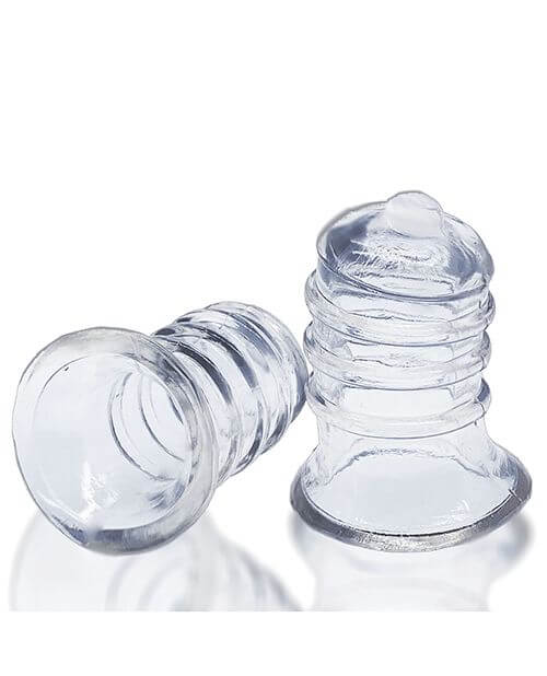Oxballs Elong Nipsuckers up against a white background. One sucker is sitting upright, resting on the base while the other sucker is tipped over, showcasing the hollow, wide interior that has a lot of space for flesh. The lip of the base is rounded for better grip. | Kinkly Shop