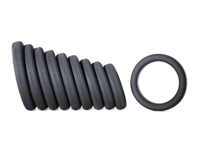 A side view of all of the Perfect Fit Play Zone Cock Ring Sizing Kit cock rings shows how they incrementally get larger in diameter. This side profile also shows that each cock ring has the words "Perfect Fit Brand" etched into the silicone. | Kinkly Shop