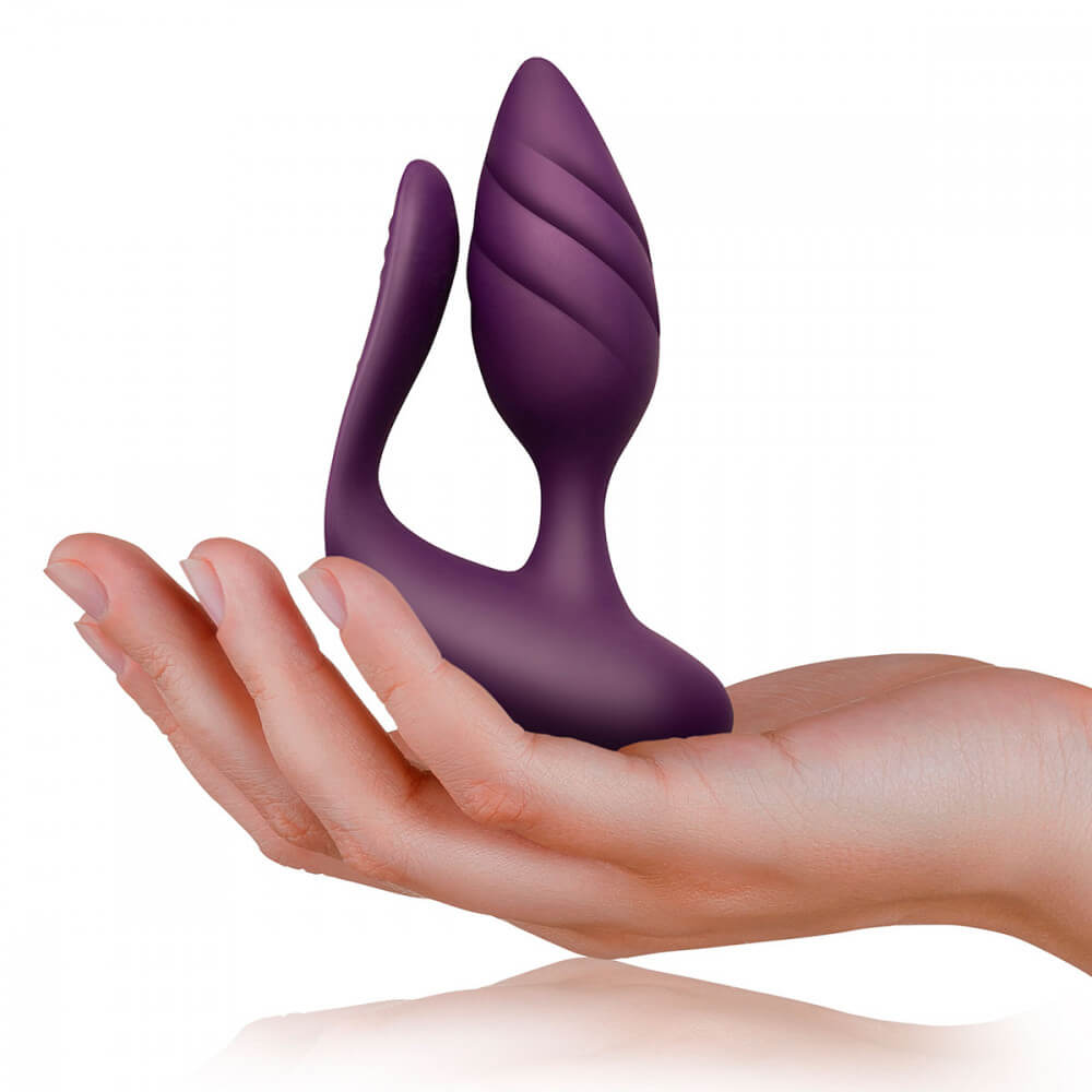 A hand holds the Rocks-Off Cocktail. This allows the viewer to see how large the plug is compared to a hand. It is definitely noticeable when held in a palm, but it does not look large. | Kinkly Shop