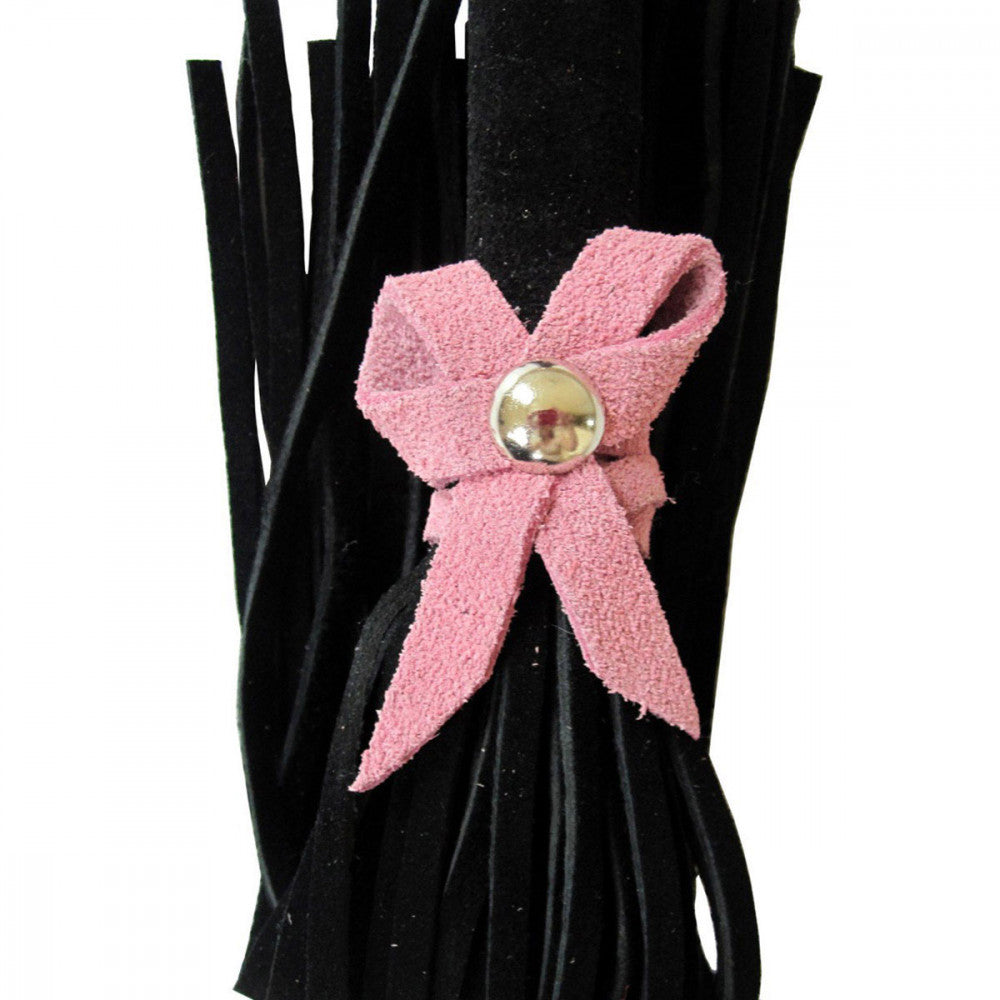 Another up-close shot that shows the suede bow detailing on the Ruff Doggie Styles Love Knot Travel Flogger. You can see the texture of the suede. | Kinkly Shop