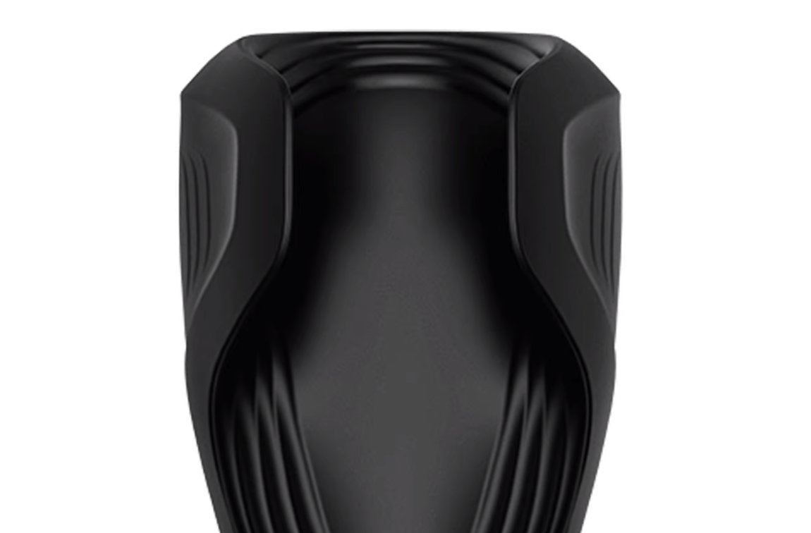 A close-up of the texturing and the winged "tabs" of the Satisfyer Men Wand. This shows the unique, futuristic look of the toy while also providing a close-up view of where the penis will comfortably rest. | Kinkly Shop