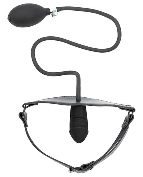 Top-down view of the Spartacus Inflatable Penis Gag laid out against a white background. The gag's strap is fastened as if it was fitted onto a person's head, and the penis gag protrudes inward to the invisible "wearer". The inflation bulb and cord hang outside of the gag with the squishy, inflation-ready bulb ready to inflate the gag at a moment's notice. | Kinkly Shop