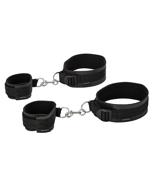 Sportsheets Thigh to Wrist Bondage Cuff Set sitting out on a white table while clipped together. | Kinkly Shop