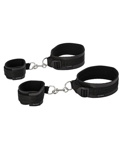 Sportsheets Thigh to Wrist Bondage Cuff Set sitting out on a white table while clipped together. | Kinkly Shop