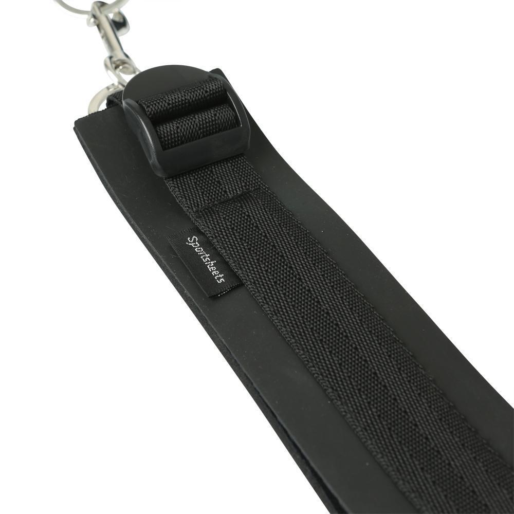 Close up of the Sportsheets Thigh to Wrist Bondage Cuff Set surface of the cuff. This shows the adjustable thigh cuff buckle, the sturdy, sewed-in nylon strap that encircles all cuffs, and the sewn-in Sportsheets tag. | Kinkly Shop