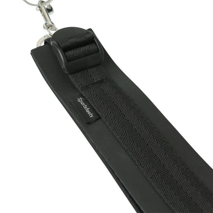 Close up of the Sportsheets Thigh to Wrist Bondage Cuff Set surface of the cuff. This shows the adjustable thigh cuff buckle, the sturdy, sewed-in nylon strap that encircles all cuffs, and the sewn-in Sportsheets tag. | Kinkly Shop