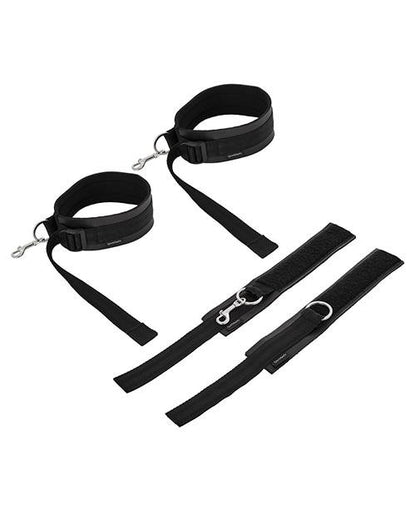 All four cuffs of the Sportsheets Thigh to Wrist Bondage Cuff Set sit out on a plain white background. The thigh cuffs are sitting upright and look like circular cuffs while the two wrist cuffs are laid flat. | Kinkly Shop