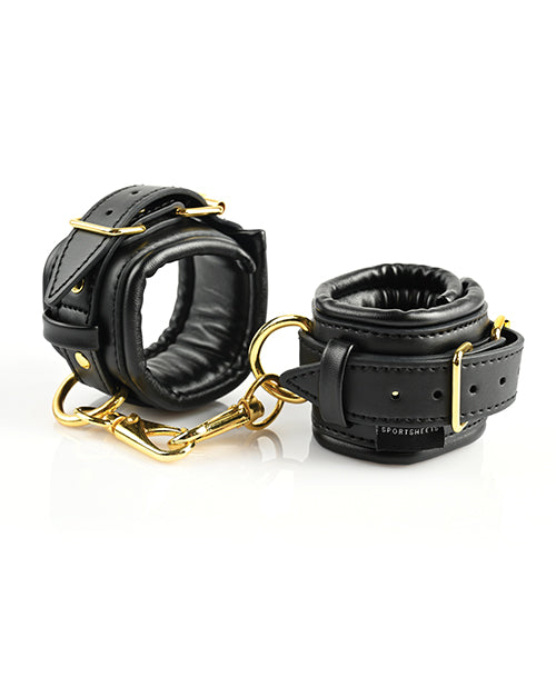 The Sportsheets Cuffs and Blindfold Set cuffs curled up into circles and fastened shut. The two, included, attached golden fasteners are attached to one another to showcase how simply these cuffs work for bondage. | Kinkly Shop