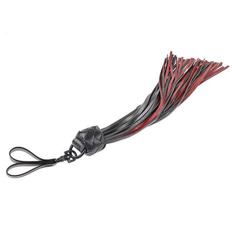 The Sportsheets Saffron Finger Flogger laid flat against a white background. The two finger loops to control the flogger are clear from this angle as well as the swivel joint that attaches the finger loops to the rest of the flogger. | Kinkly Shop