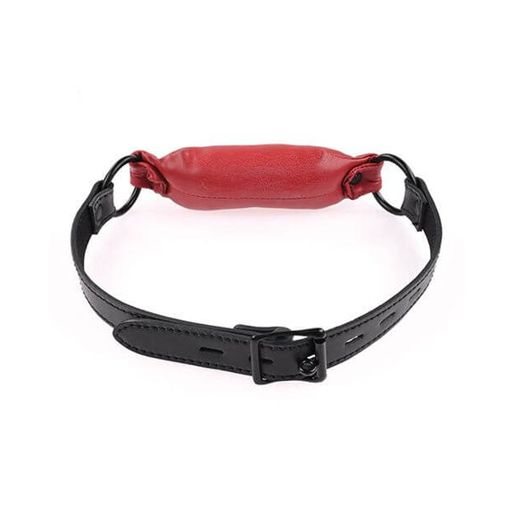 Close-up on the buckle of the Sportsheets Saffron Soft Bit Gag. This showcases the circular buckle on the buckle that allows you to lock the gag onto the head if desired. It will still fasten without the lock. | Kinkly Shop