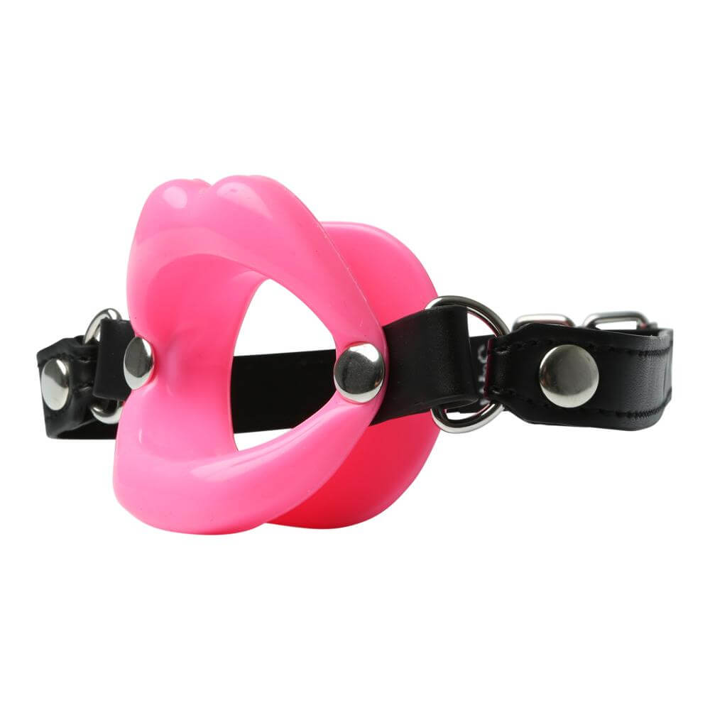 A 3/4ths angle view of the Sportsheets Silicone Lips Mouth Gag. This showcases how the interior of the gag is completely open, and it also showcases the "lips" molding on the front of the gag. There's clear divet between the front and the back sides of the gag itself where the lips are designed to comfortably rest to hold the gag in place. | Kinkly Shop