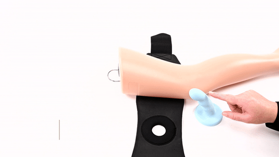 GIF of a person sliding a dildo into the built-in O-ring of the Sportsheets Ultra Thigh Strap-On Harness before wrapping it around a mannequin leg. The harness goes on in literal seconds. | Kinkly Shop
