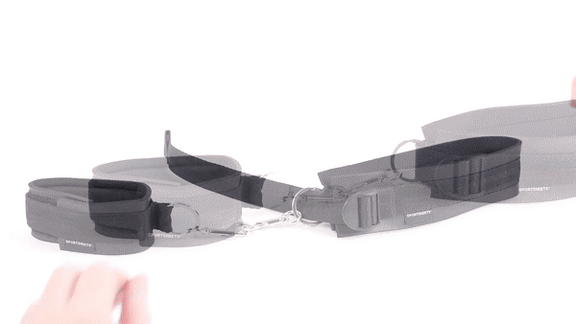 GIF shows the wrist cuff and thigh cuff sitting out together and fastened together. Two hands come in and unclip the cuffs then reclip the cuffs together to show how easily these bondage cuffs come apart. | Kinkly Shop