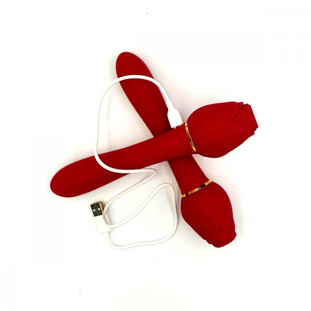 Two Suckle Rose Vibrators sitting on top of one another. The top one has the magnetic charging cable attached to the charging port. | Kinkly Shop
