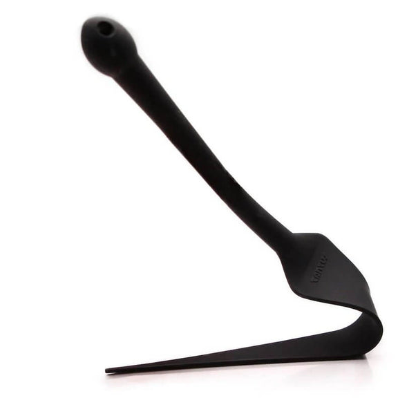 The Tantus Dragon Tail pressed up against a flat surface. The toy bends, easily, with no resistance. The tail of the Tantus Dragon Tail is extremely flexible. | Kinkly Shop