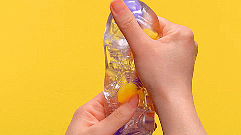 GIF of two hands holding the Tenga Bobble. They are pushing and squeezing the stroker to showcase how the firmer, internal shapes can be pushed around for masturbation play. | Kinkly Shop