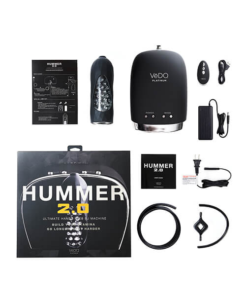 All of the pieces to the hands free male sex toy laid out on a lay flat, top-down image. The image shows the main power unit, the remote control, the remote control charging cable, the power cable for the main unit, the penis stroker, the instructions, the packaging, more instructions, the power brick for the main unique, and other accessories for the VeDO Hummer 2.0 | Kinkly Shop