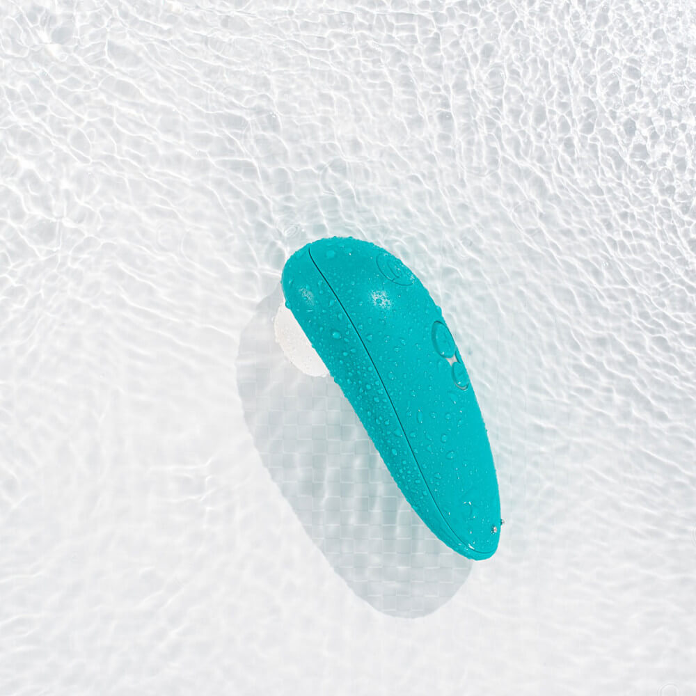 The Womanizer Starlet 3 rests in a pool of water. This is to show off the air suction vibrator's waterproof capabilities. | Kinkly Shop