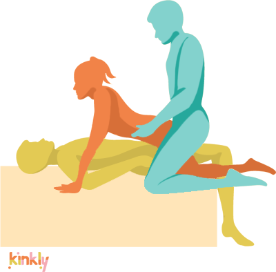 Double Stuffed Threesome Sex Position: The bottom-most partner is lying on their back on a flat surface. They are penetrating the middle partner, who is straddling them face-to-face with their hands next to the bottom-most partner's shoulders and their knees outside the bottom partner's thighs. The top partner is penetrating the middle partner from behind, kneeling with their knees on either side of the middle partner's knees. 