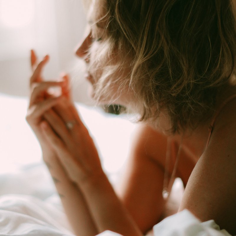 blurred image of woman in bed