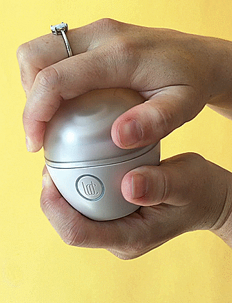 The Lora DiCarlo Baci: Gif of hands opening an egg-shaped sex toy to reveal an oval suction cup on the bottom half.
