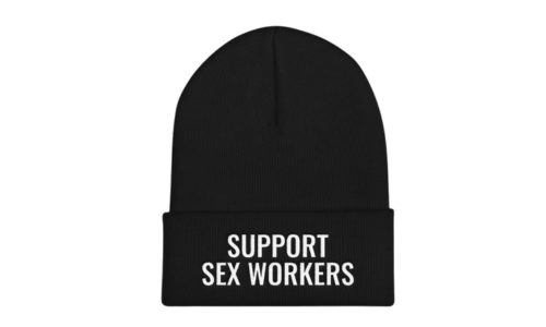 A black beanie that says support sex workers on the front in white text