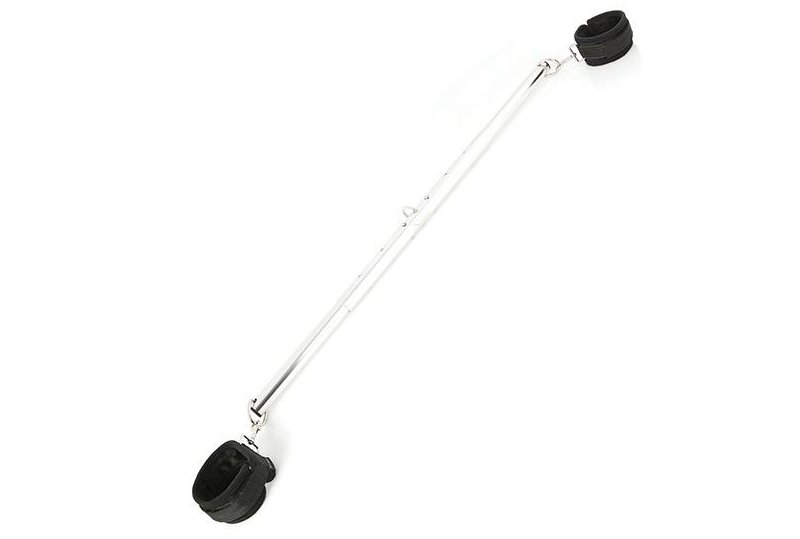 The Sportsheets Expandable Spreader Bar and Cuff set includes a long, metal bar with two bondage points on the end of each side of the bar. Attached to these each one of these bondage points is a black bondage cuff. Not shown, but the bar can be taken apart into three pieces for easy storage. | Kinkly Shop