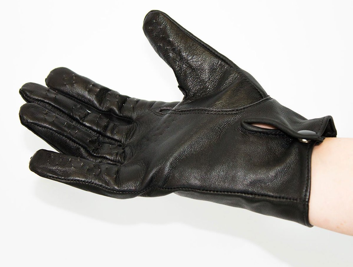 Vampire Gloves: A hand dons a black leather glove with miniature spikes protruding from the fingers.