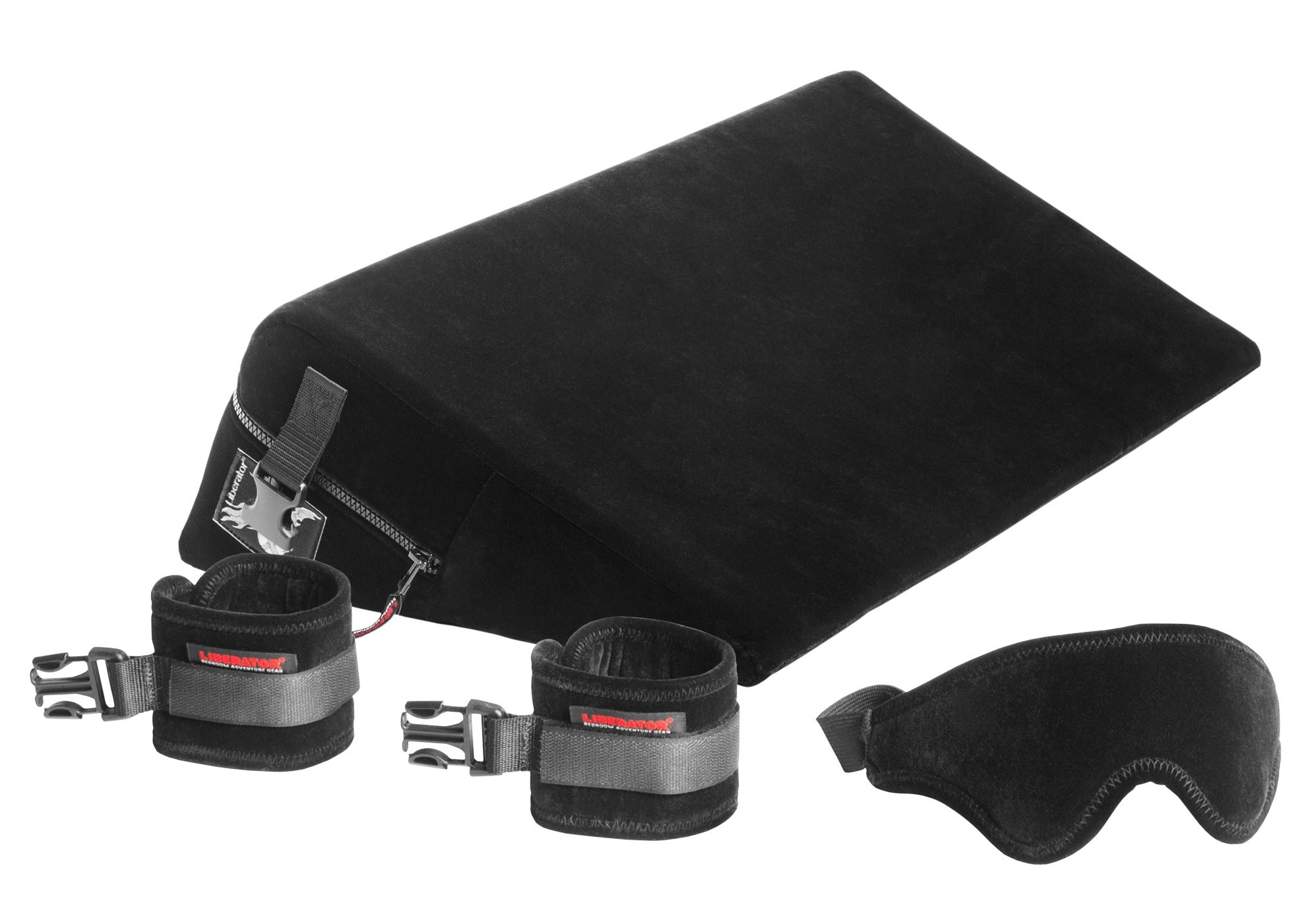 The Liberator Black Label Wedge: A wedge-shaped piece of foam with built-in bondage points is pictured next to black cuffs and a black blindfold.
