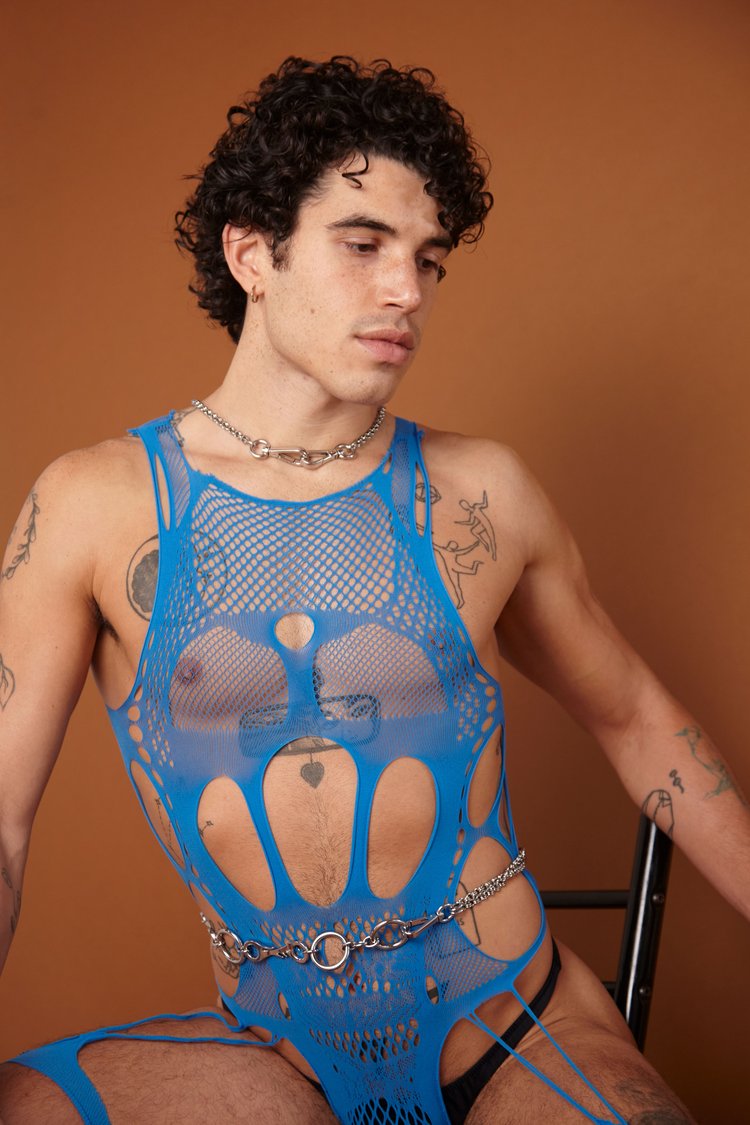 Person wearing sex, fishnet like lacy bodysuit in blue