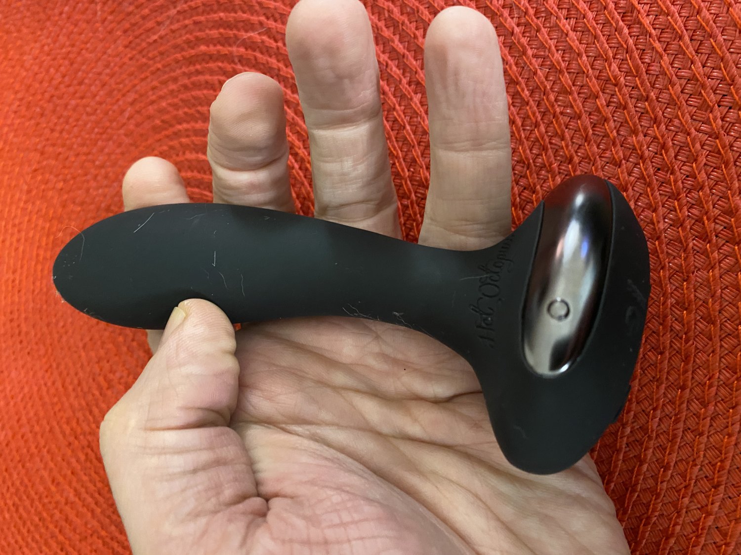 A person holds the PleX with Flex in their hand. The shaft of the plug looks slim compared to the hand.