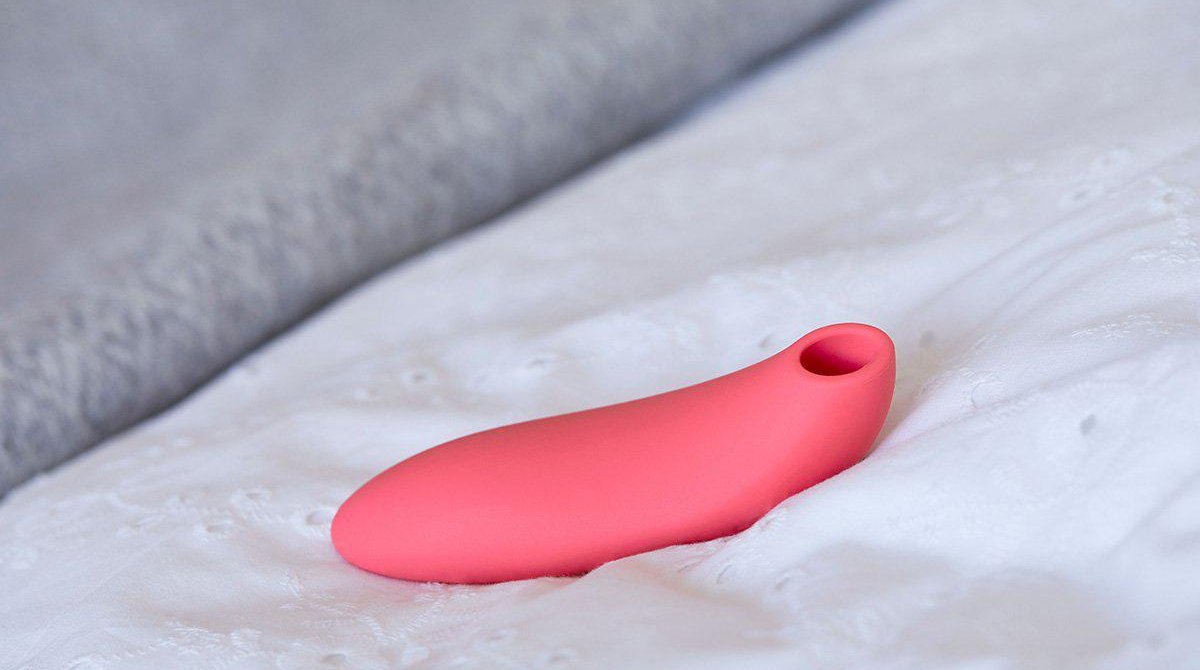 The We-Vibe Melt: A finger-shaped neon pink sex toy with a suction tip.